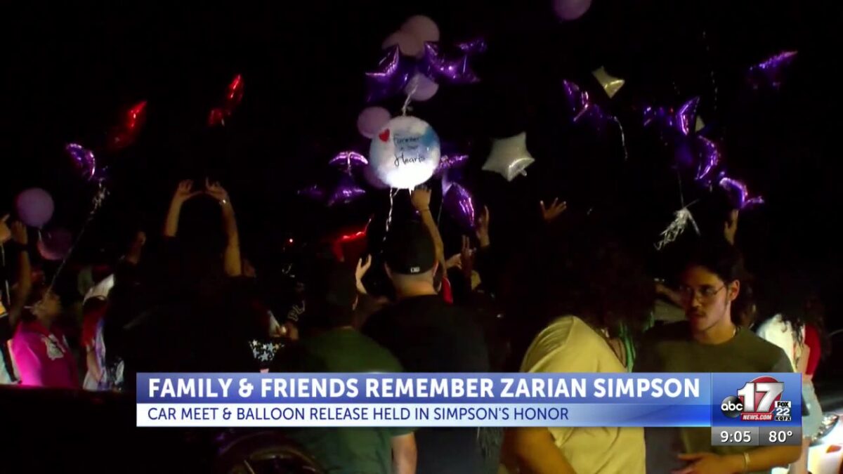 Community members release balloons in honor of slain teen