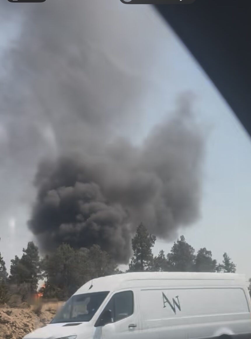 Crews contain apparent vehicle fire which broke out off Highway 97 in north Bend near the homeless encampment ‘Dirt World’