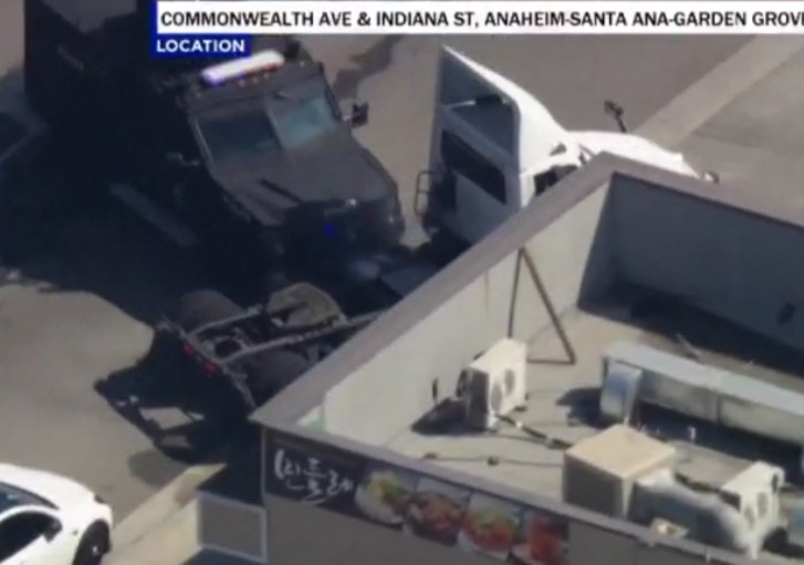 An armored SWAT vehicle rammed into the side of a big rig being driven by a kidnapping suspect on Wednesday