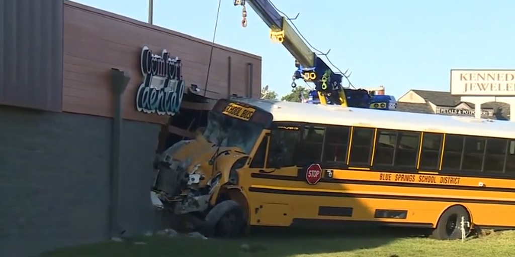 At least four people were taken to an area hospital after a school bus slammed into a building in Blue Springs early Thursday morning.