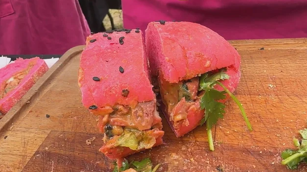 Reuby Indian Taqueria's hoagie is a hot pink roll filled with tandoori chicken salad and salsa verde chutney.