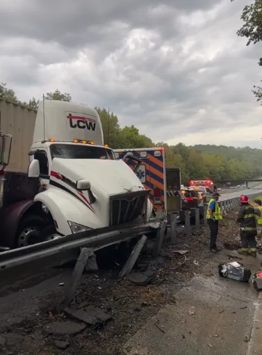 An early-morning crash on Interstate 26 East in Polk County involving two tractor-trailers and two Polk County EMS vehicles sent one person to the hospital with minor injuries