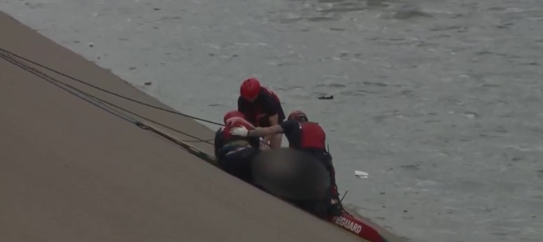 City and county rescue personnel saved the victim from being swept away.