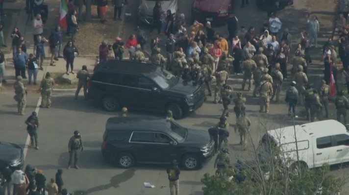 Federal agents fired tear gas to disperse a crowd during a tense standoff on Chicago's far South Side Tuesday afternoon