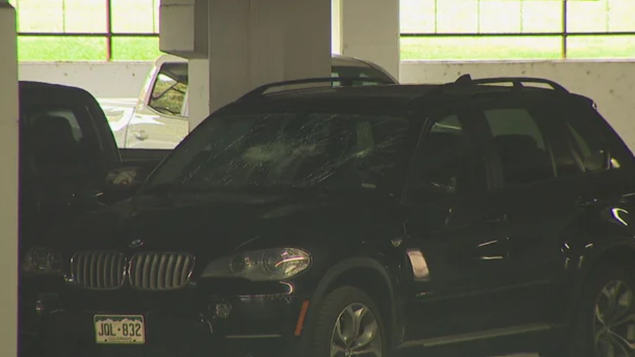 Multiple vehicles and bicycles damaged in University of Denver parking lot.