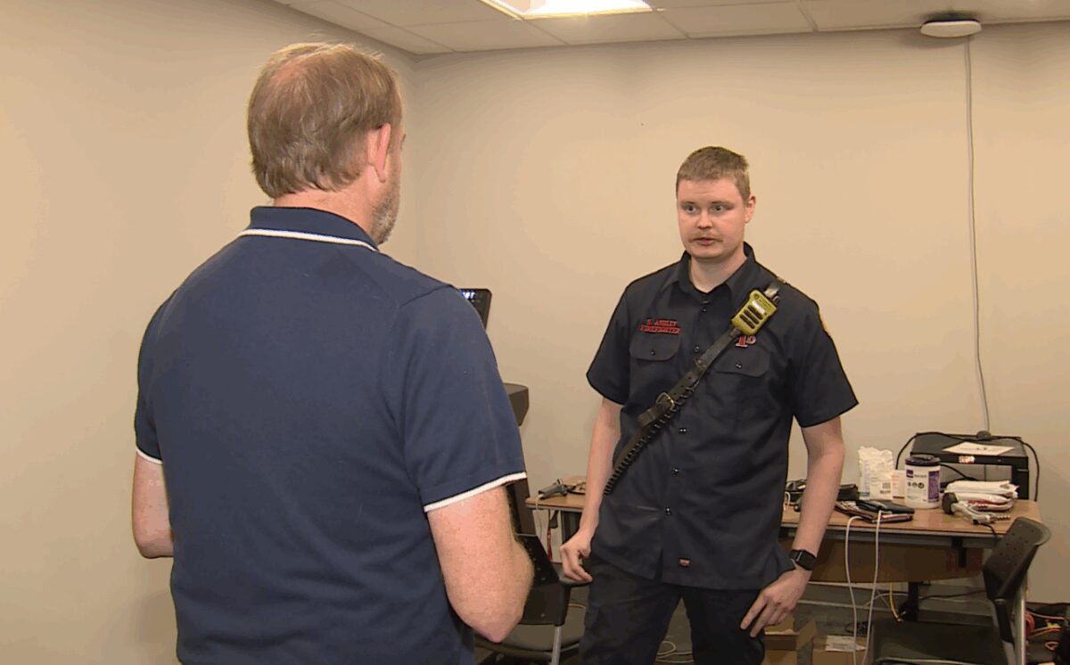 KSHB 41 News reporter Tod Palmer (left) speaks with Independence Firefighter Spencer Ashley.