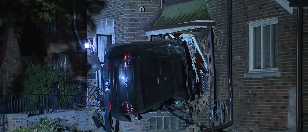 A vehicle crashed sideways into a house on Roselawn Street in Detroit.