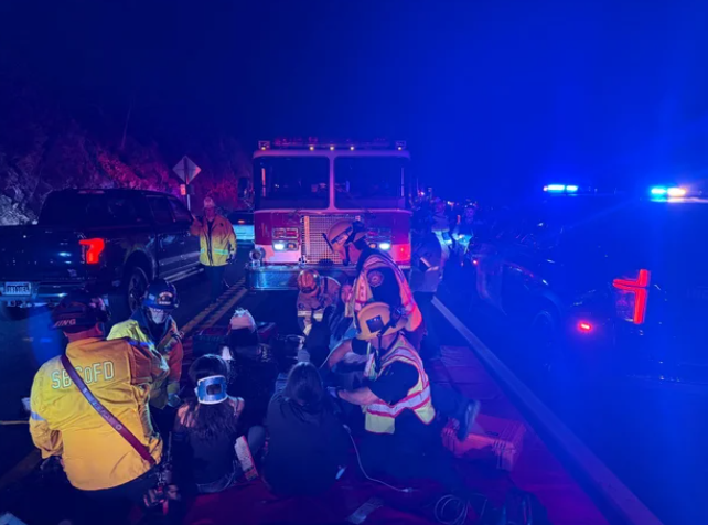 Firefighters treating victims of the overturned bus crash on Highway 330 on Nov. 9.
