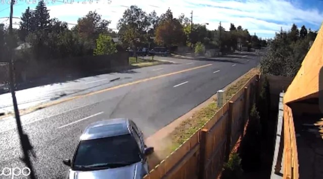 A home security image shows a speeding car leaving Peoria Street and heading into the property of a homeowner.