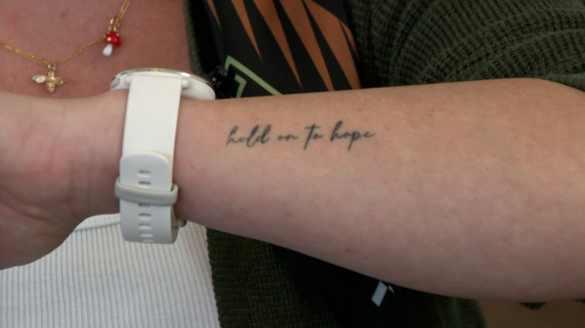 Hunter Baker shows her tattoo