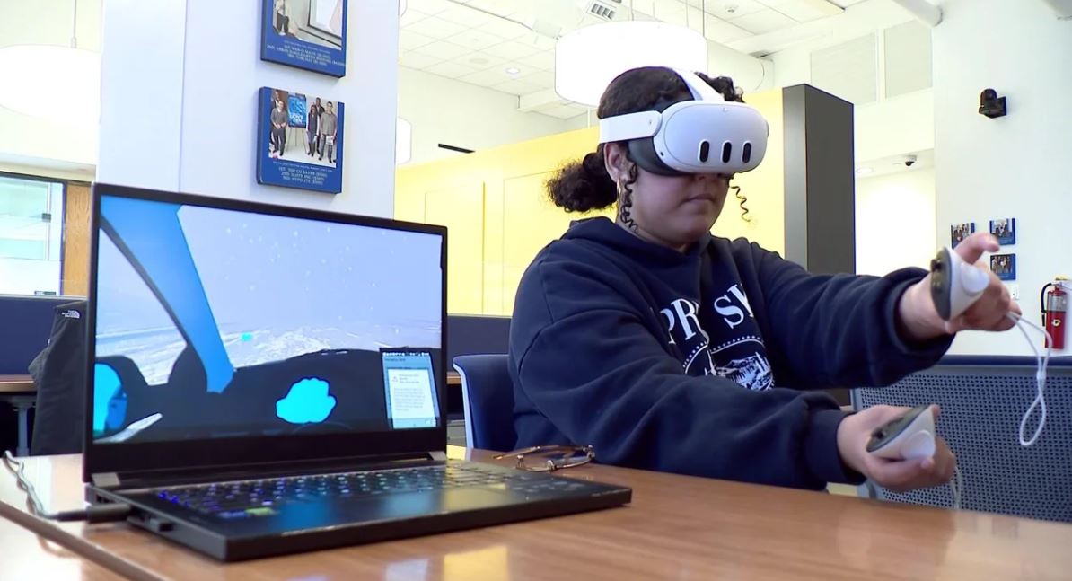 Hofstra student Adalia Rezkie tries the VR driving simulator.