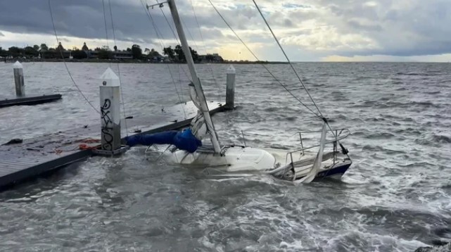 A sailboat is partially submerged at the Encinal Boat Ramp in Alameda. Nov. 5