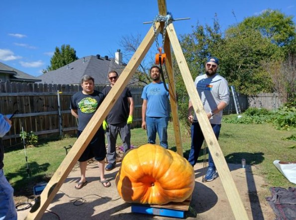David Weindel (left) grew this pumpkin in his backyard in Bossier City.