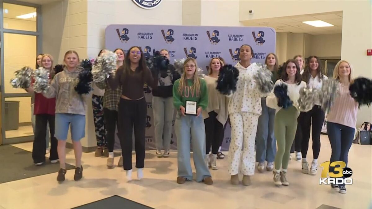 The Air Academy cheer team receives the Qdoba Friday Night Blitz Spirit Award plaque
