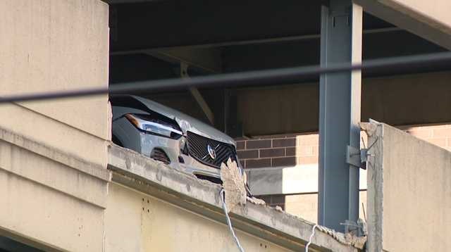 Police are investigating after a vehicle was left partially hanging from a UPMC hospital parking garage after crashing into a barrier Tuesday afternoon.