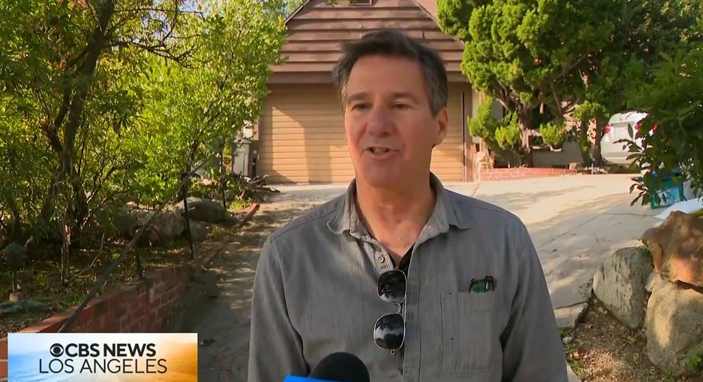 Johnson says that when he went to the side yard to replace the batteries on the camera