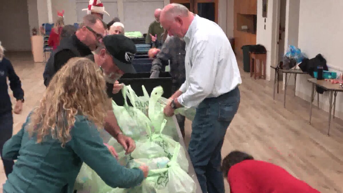 Volunteers Continue to Help for the Holidays in the Rain With Food and Tarps