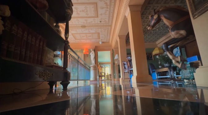 A wrap-around balcony circles the exterior