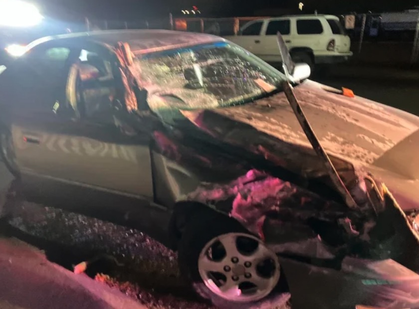 A handout photo from Commerce City police shows a damaged car that investigators say was involved in a deadly hit-and-run. The driver allegedly took his injured passenger home in this car
