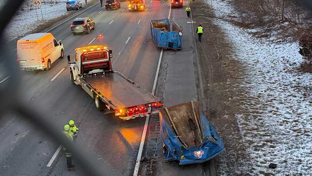 The truck that was carrying the dumpsters may have struck the Centre Street overpass on the northbound side of the highway near Exit 69 causing the dumpsters to fall onto the road