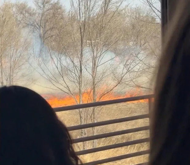 A fire in the northern part of the Denver metro area crept close to a school on Wednesday and created a frightening scene for some students. In the middle of the school day they spotted smoke and flames in the field outside the windows.