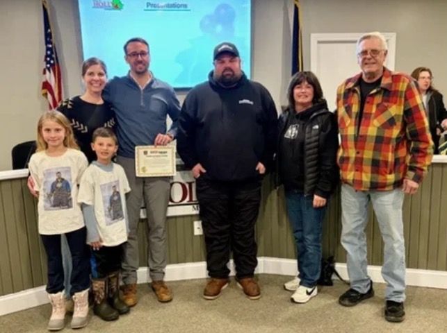 The Holly Police Department presented a life saving award to a bystander who assisted a snowmobiler who fell through the ice in Oakland County