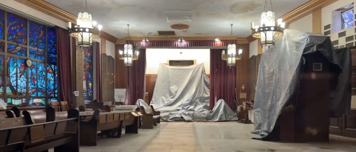 The once-vibrant Kingsbrook Shul is now covered in tarps