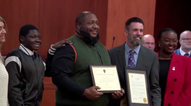 A DeLand man who intervened during a violent confrontation and saved a child from an alleged knife-wielding attacker was honored this week with a Distinguished Citizen Service Award.