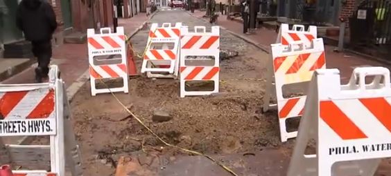 A large sinkhole that appeared on a historic street in Philadelphia's Old City neighborhood around Christmas has continued to disrupt traffic and frustrate neighbors and nearby businesses