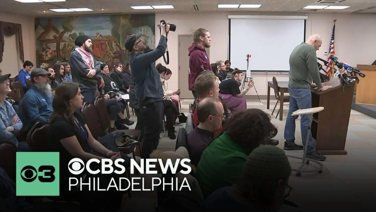 Some residents held signs reading "fire and arrest Scott McElree" as they called for answers about a confrontation between police and students during the protest.
