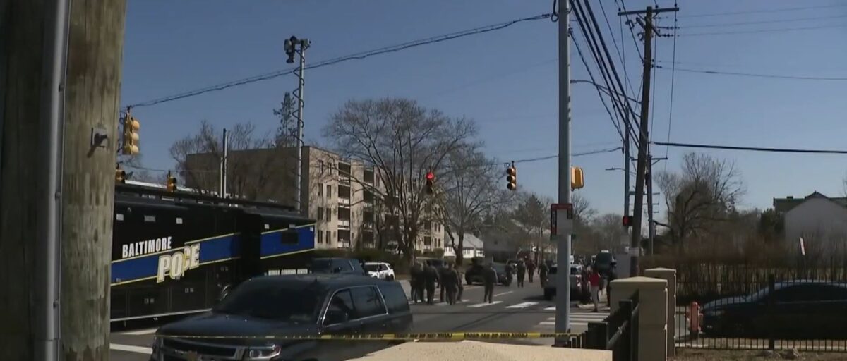 A witness captured video of Baltimore police officers hustling to a home on Park Heights Avenue in response to a hostage standoff on Tuesday.