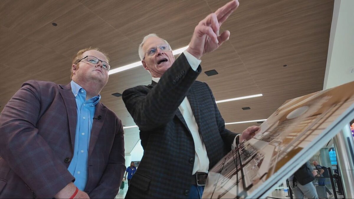 Reporter Chris Davis looks on as Nashville International Airport CEO Doug Kreulen shows him the proposed renovation project.