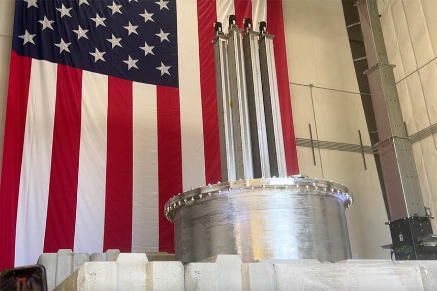 Aalo Atomics’ nuclear reactor sits below a 50-foot by 30-foot American flag during Thursday’s unveiling