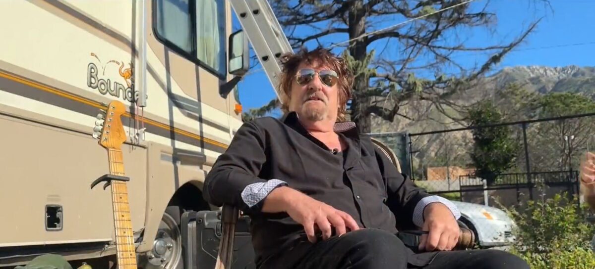 Terry Kilgore sits in an upholstered wooden chair