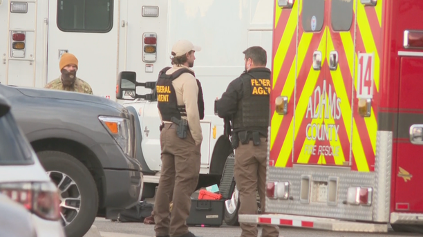 Federal agents and local fire rescue and hazmat officials are seen at the Hau Processing facility in Adams County