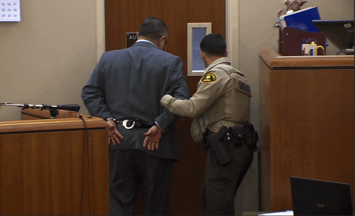 Dr. Carlos Chacon is taken away in handcuffs at his 2024 sentencing where he was given a three-year prison sentence.
