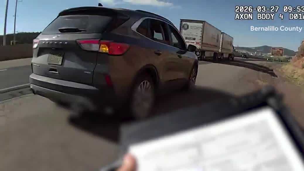 State law requires motorists to yield to emergency vehicles pulled over on the side of the road. Note: License plate has been blurred.