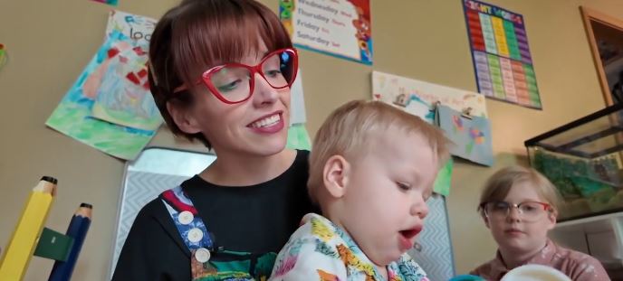 Hudson uses his AAC (Augmentative and Alternative Communication) device to communicate.