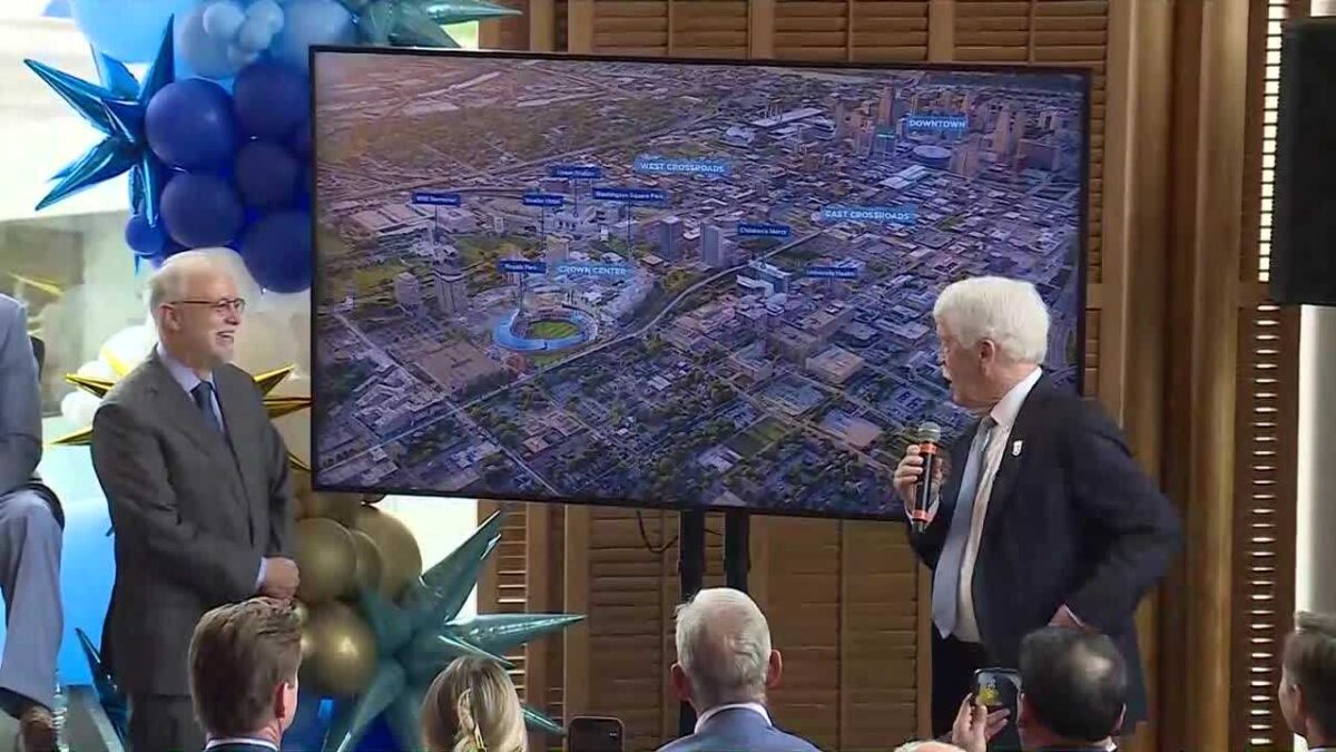 Don Hall Jr. and Royals CEO and Chairman John Sherman show off plans for new Royals stadium.
