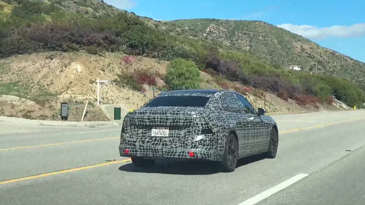 BMWs wrapped in camouflage cruise the coast