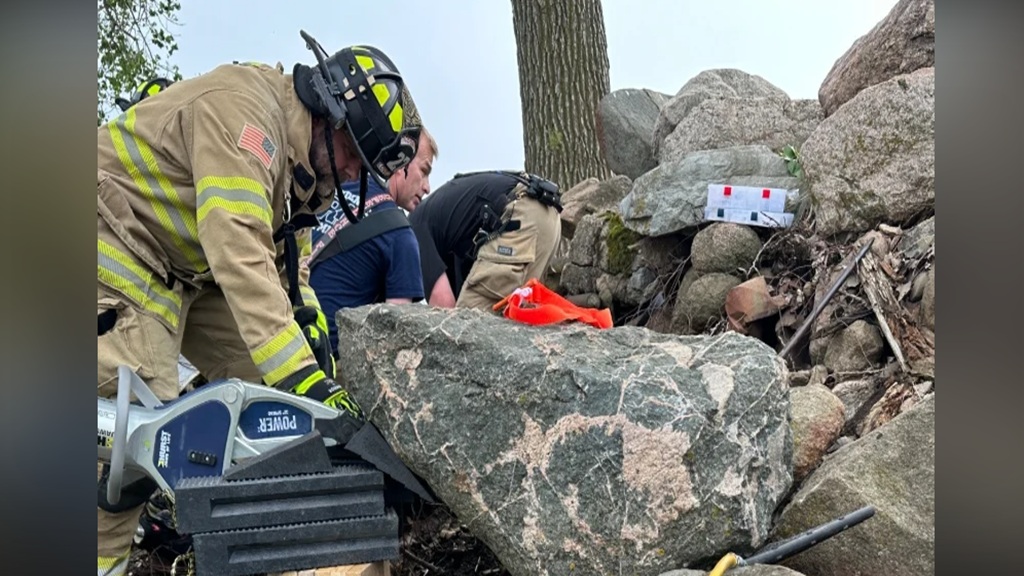 A woman was rescued after a large rock shifted and pinned her legs on Overland Boulevard Monday.