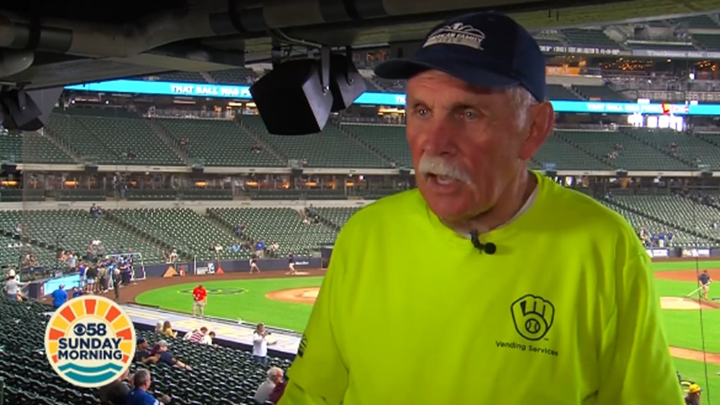The man selling the hot dogs is Steve Carlovsky who said eating hot dogs at a baseball game is "a tradition!