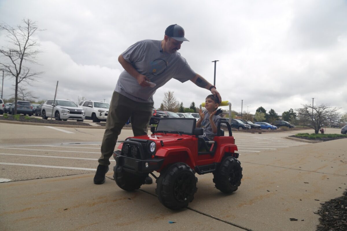 Angelo Vincenzo with his son Vincenzo in their new Go Baby Go car from Children's Wisconsin.