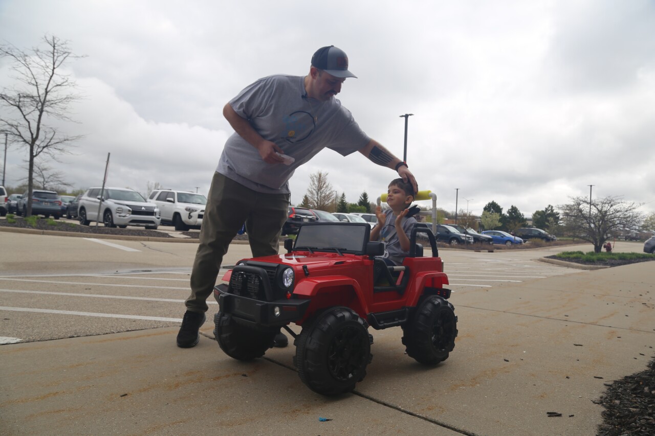 Angelo Vincenzo with his son Vincenzo in their new Go Baby Go car from Children's Wisconsin.