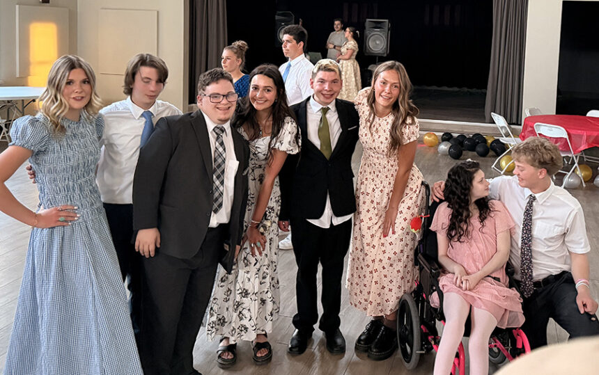 Kaleb Brock and Brie Belnap are pictured with friends at special needs prom.