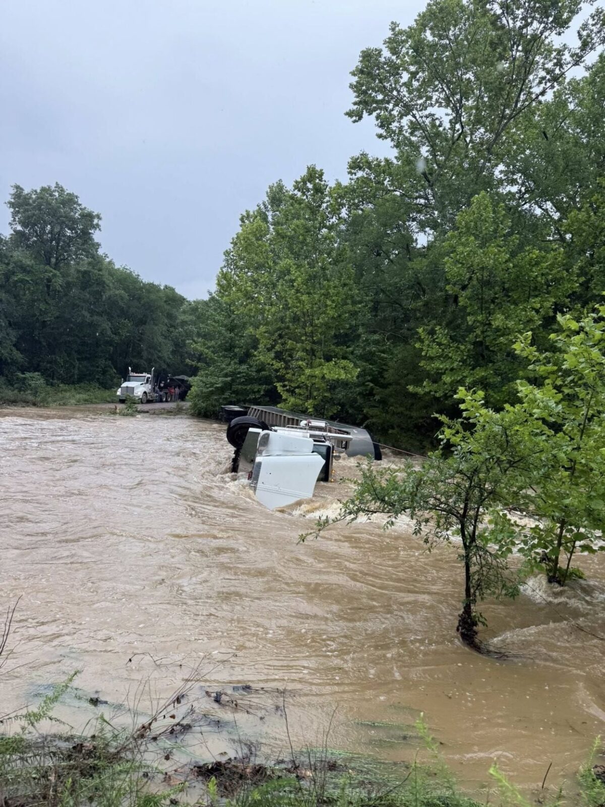 First responders rescued a truck driver after his vehicle was swept away by floodwaters in McCurtain County on Wednesday afternoon.