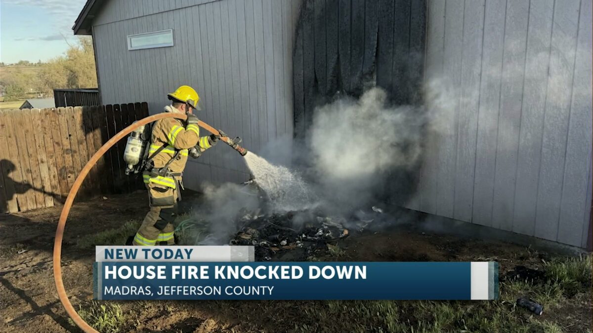 Early morning structure fire contained to exterior of Madras home