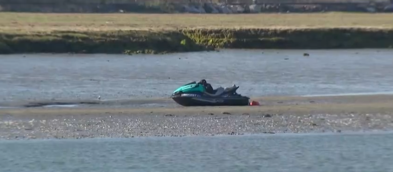One of the men rescued said he and a friend were trying to swim to shore after the jet ski got stuck.