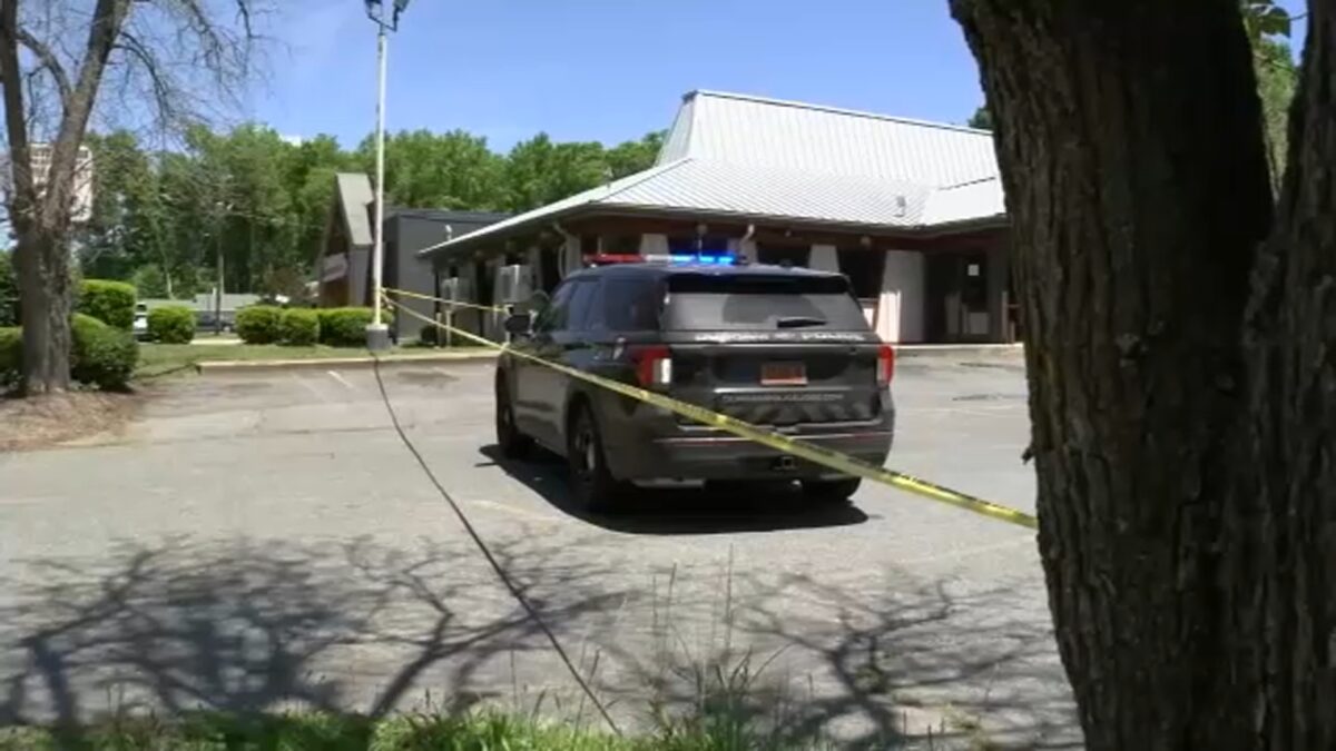 One person was critically injured and a man is facing charges after a shooting at a business along North Roxboro Street late Sunday morning