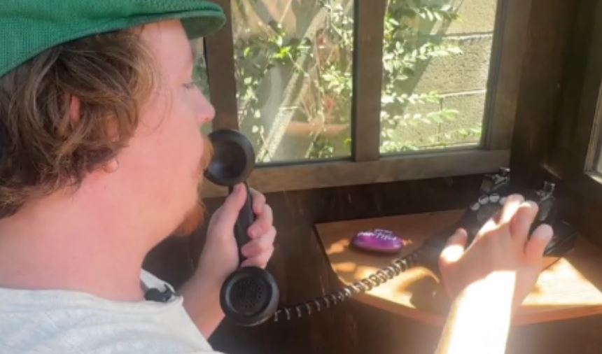 A phone booth in Altadena has an old black rotary phone that doesn't ring or have a busy signal